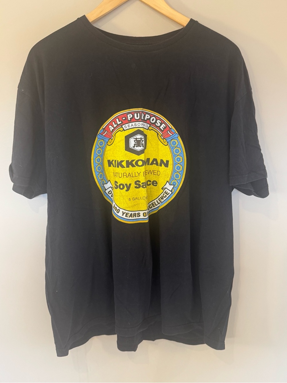 Black Short Sleeve Tee with Yellow Logo Badge